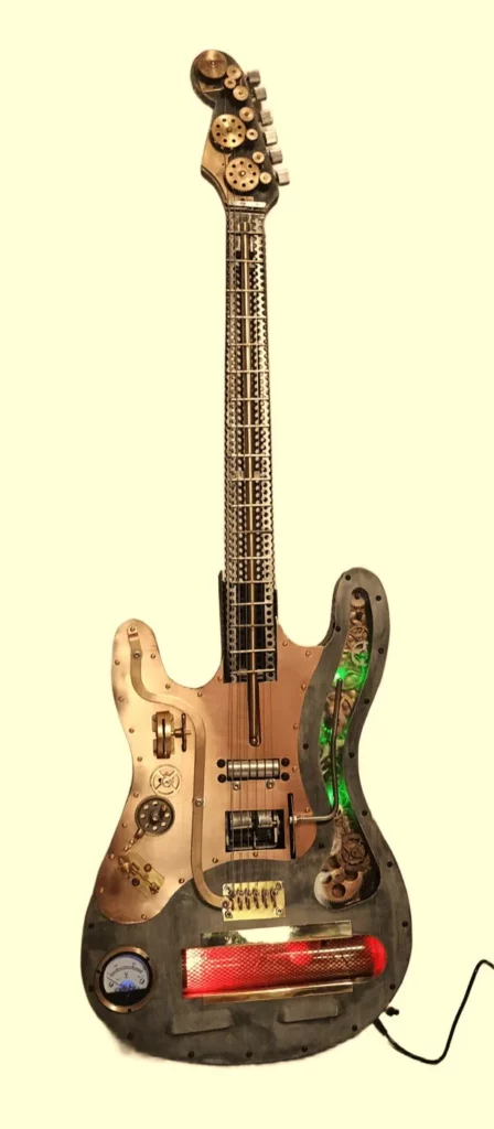 Sculpture guitare Stratocaster en métal recyclé avec engrenages, LED et ampèremètre