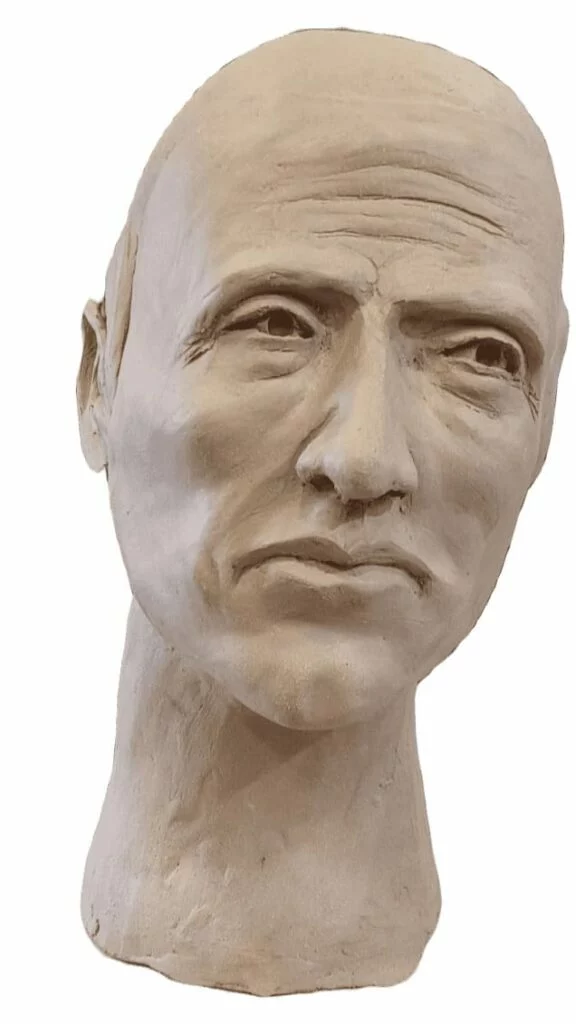 Portrait masculin modelé en argile, vu de face. Sculpture de Bruno Cotton.